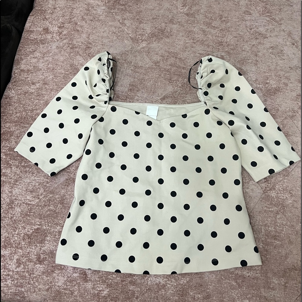 Cream colored top with black polka dots